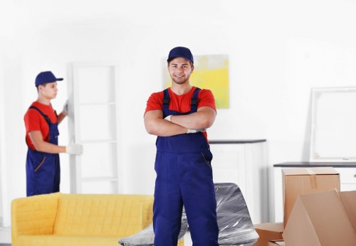 Removal team handling furniture in Bermondsey street setting
